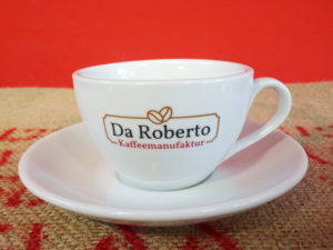 Milchkaffee Ober- und Untertasse mit Da Roberto Logo auf Kaffeesack
